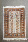 A Bokhara rug with elephant's foot pattern on a light blue field,