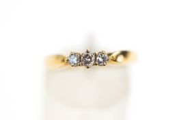 A 9 carat gold three stone diamond ring, the graduated brilliant cuts totalling approximately 0.