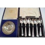 A cased set of six silver coffee spoons; another similar set of six;