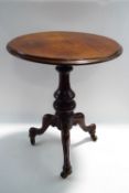 A Victorian and later mahogany tripod table, on scroll legs raised on brass castors,