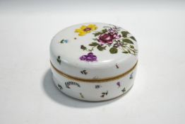 A Meissen style circular ceramic dressing table pot and cover, with hand painted flower decoration,