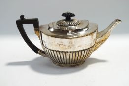 A silver teapot, by Martin & Hall, Sheffield 1903, of oval gadrooned form, 28 cm long, 724 g (23.