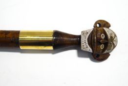 A Malacca shafted walking stick with carved tribal head knop