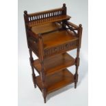 A mahogany three tier whatnot with raised mirrored back,