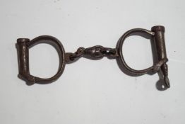 A pair of steel handcuffs,