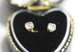 A pair of single stone diamond earrings, the brilliant cuts totalling approximately 0.