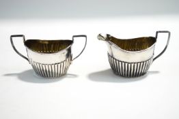 A silver cream jug and sugar bowl, Chester 1903, of oval gadrooned form, 152 g (4.