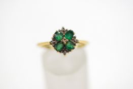 An 18 carat gold emerald and diamond cluster ring,