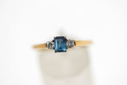 A 9 carat gold blue topaz and diamond three stone ring,