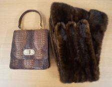 A crocodile skin handbag together with a mink stole