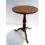 A mahogany tripod table with fixed top,