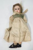 A French bisque head Tete Jumeau doll, printed red marks to neck, 49cm high,