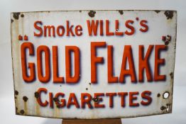 An enamel advertising sign "Smoke Will's Golden Flake Cigarettes", 91.