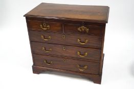A George III mahogany chest of two short and three long drawers with brushing slide,