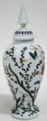 A Victorian milk glass vase and cover, painted in enamels with flowers and butterflies,