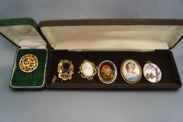 A collection of five costume jewellery brooches, including one issued by the British Museum,