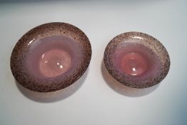 A Monart pink and gold aventurine glass dish, 18.5cm diameter, and a smaller matching example, 14.