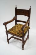 A Victorian oak armchair with carved detail and rush seat,