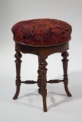 A Victorian mahogany piano stool with tapestry style floral seat,