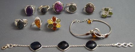 A collection of nine silver and silver coloured rings and two bracelets