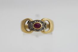 A 9 carat gold ruby and diamond ring, the cabochon enclosed by illusion set single cut stones,