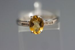 A stone set ring, stamped '10k' to the white mount, finger size N, 1.