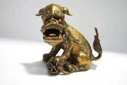 A Chinese polished bronze figure of a Dog of Fo with a flaming pearl,