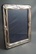 A modern silver photograph frame, of rectangular outline, 23 cm by 18.