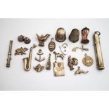 A collection of silver and silver coloured charms; two thimbles; a propelling pencil;