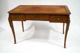 A 20th century French mahogany and kingwood writing desk, with leather inset top,