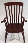 A stained beech stickback armchair on turned legs