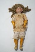 A large German bisque headed doll, impressed marks to the neck and 167,