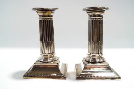 A pair of Victorian loaded silver desk candlesticks, by Harrison Brothers and Howson,