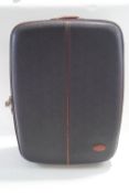 A Mulberry black suitcase with tan leather trim, handles and logo label,