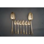 A pair of silver serving spoons, London 1818, and a set of six silver tea spoons, London 1799,