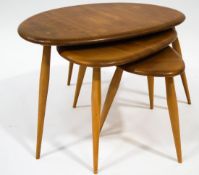 An Ercol nest of three 'Pebble' tables, the largest 40cm high,