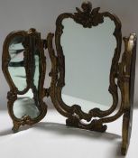 A triple dressing table mirror with gold effect rococo 'C' scroll frame,