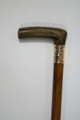 A Malacca shafted walking stick with horn handle and 1 1/4" wide collar