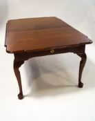An American walnut dining table with shaped corners and single drawer, three additional leaves,