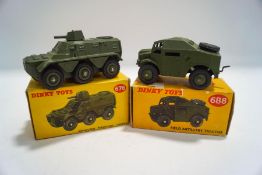 A Dinky 676 Armoured personnel carrier, boxed and a 688 Field Artillery tractor,