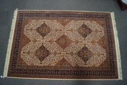 A Persian style carpet with repeating medallions to the central field, upon a neutral ground,