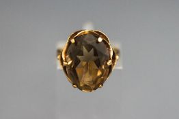 A 9 carat gold ring, set with an oval cut smoky quartz, finger size J, 4.