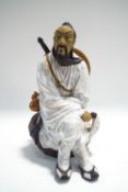 A Chinese Mudman figure of a seated warrior,