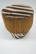 An African tribal drum with zebra skin covering,