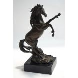 A modern bronze sculpture of a rearing horse, on a marble base,