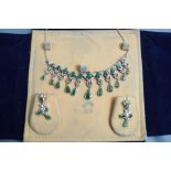 A continental diamond and emerald fringe necklace, set in unmarked white metal,