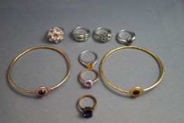 A collection of five silver and silver coloured stone set rings; two gilded rings;