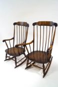 A pair of Ercol style beech rocking chairs with stick backs