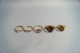 A 9 carat gold signet ring; with another similar; and three other rings; 8.