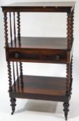 A Victorian rosewood three tier whatnot with barley twist and spindle supports and single drawer,